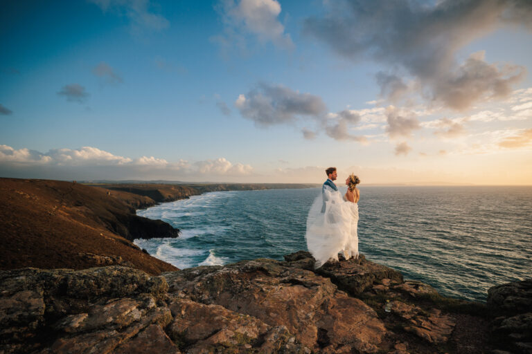 Beth and Brendan on their wedding day on the cliff top above the ocean at St Agnes, Cornwall captured by Chris Armstrong Photography