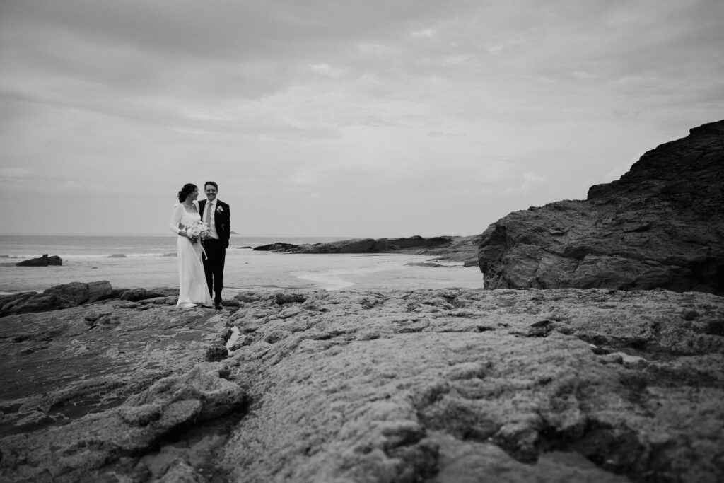 Al and Jen newly married and enjoying the beach during their micro wedding in cornwall.Captured by Cornwall Wedding Photographer Chris Armstrong Photography
